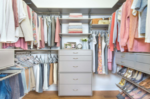 Well-organized walk-in closet, including dresser, shoe rack and shelving.
